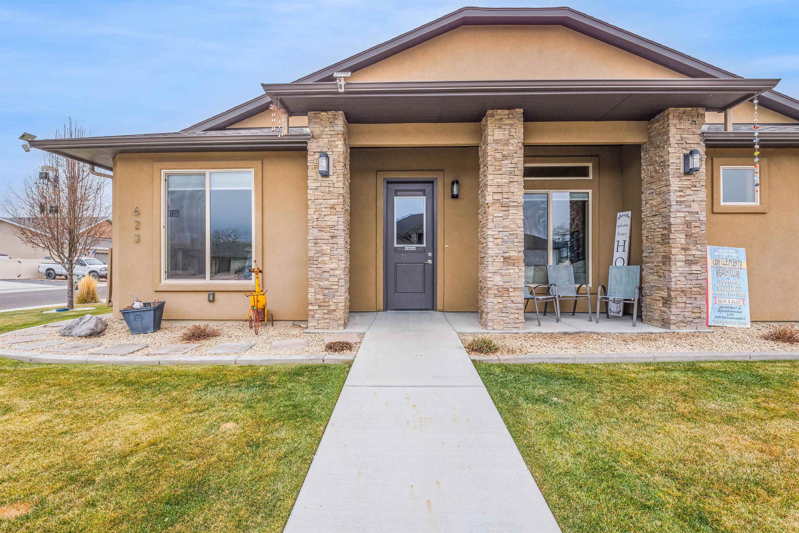 623 Thunder Ridge Drive Grand Junction, CO 81504 - Photo 7 of 40 a front view of a house with swimming pool and porch
