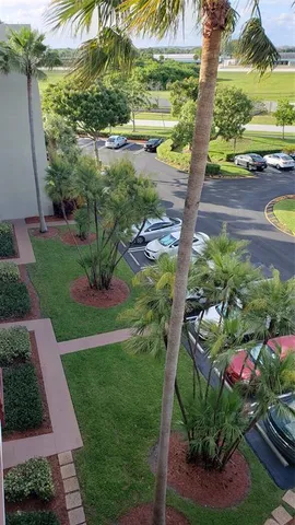 a view of a street with a cars parked in front of it