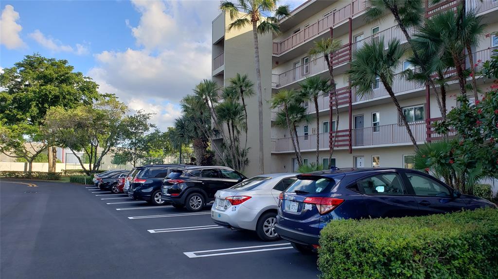 2216 North Cypress Bend Drive, Unit 504 Pompano Beach, FL 33069 - Photo 17 of 33 a couple of cars parked in front of a building