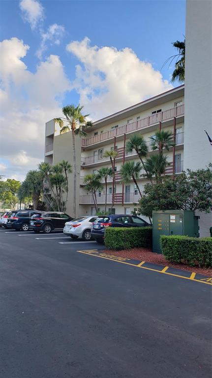 2216 North Cypress Bend Drive, Unit 504 Pompano Beach, FL 33069 - Photo 18 of 33 a view of a street with a cars parked in front of it