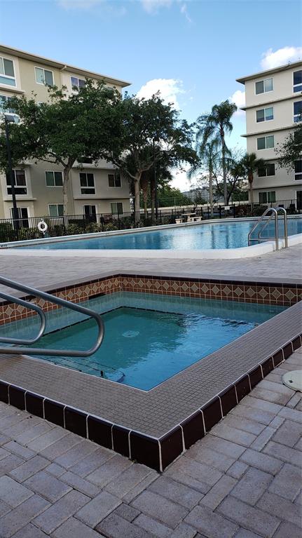 2216 North Cypress Bend Drive, Unit 504 Pompano Beach, FL 33069 - Photo 22 of 33 a view of a swimming pool with a balcony