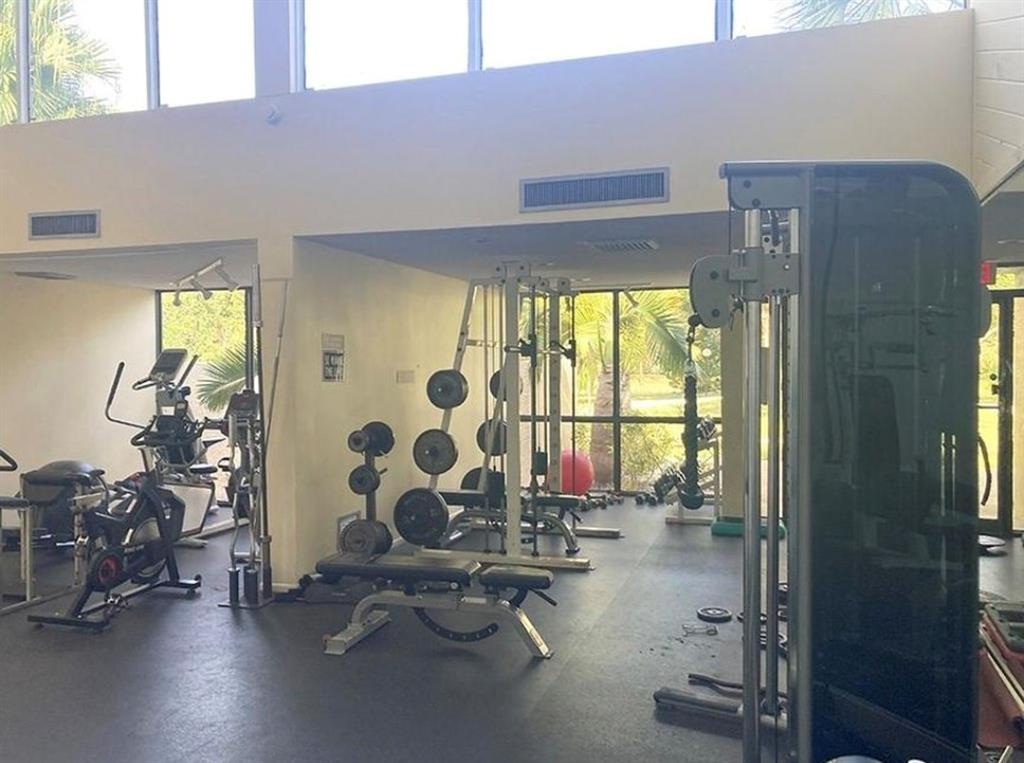 2216 North Cypress Bend Drive, Unit 504 Pompano Beach, FL 33069 - Photo 28 of 33 a view of a room with gym equipment