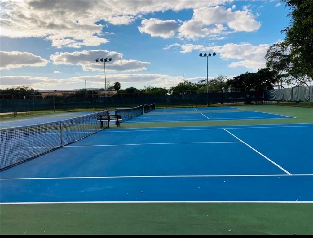 2216 North Cypress Bend Drive, Unit 504 Pompano Beach, FL 33069 - Photo 30 of 33 a view of an outdoor space and tennis court