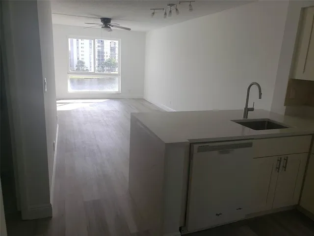 a kitchen with a refrigerator a sink and cabinets