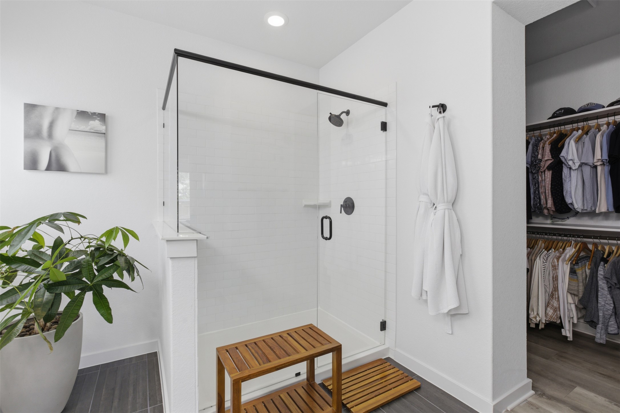 9001 Spire View Austin, TX 78744 - Photo 22 of 35 Walk-in shower with clear glass enclosure and matte black fixtures, featuring white subway tile surround