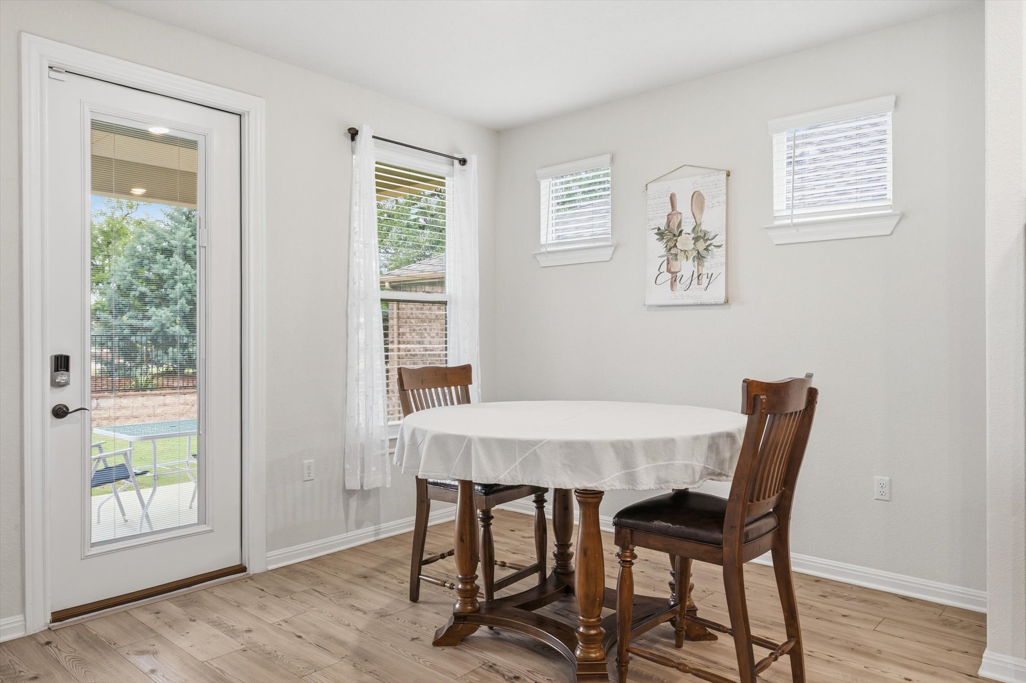 113 Lafayette Street Georgetown, TX 78633 - Photo 15 of 39 Interior space featuring wood-finish flooring, white baseboards, and a glass-paneled exterior door