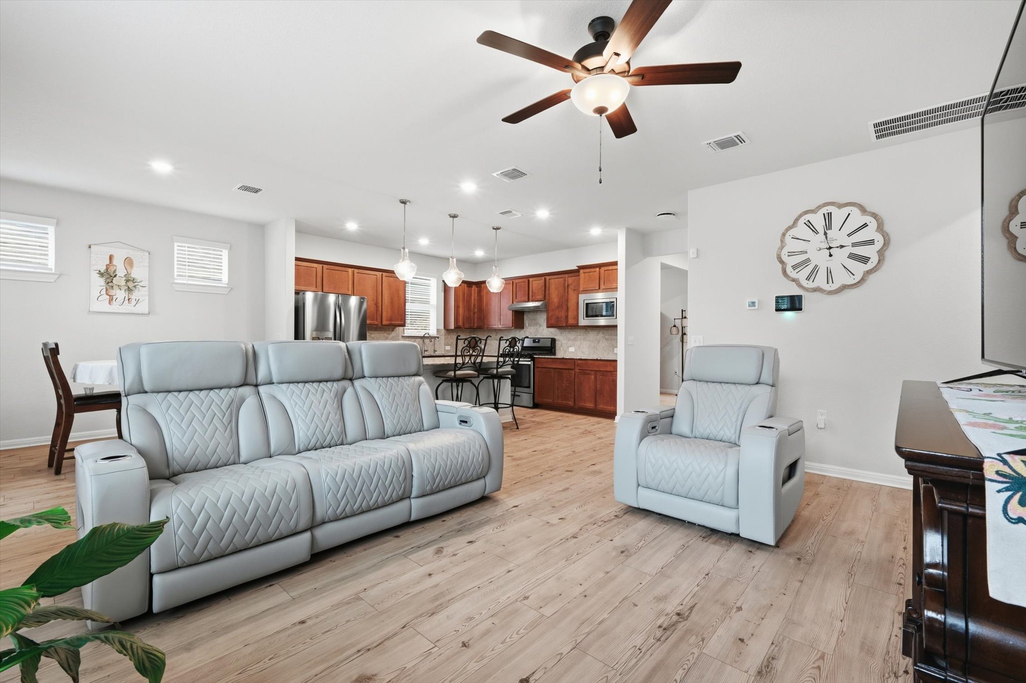 113 Lafayette Street Georgetown, TX 78633 - Photo 18 of 39 Open concept living area featuring wood-finish flooring and a ceiling fan with integrated lighting