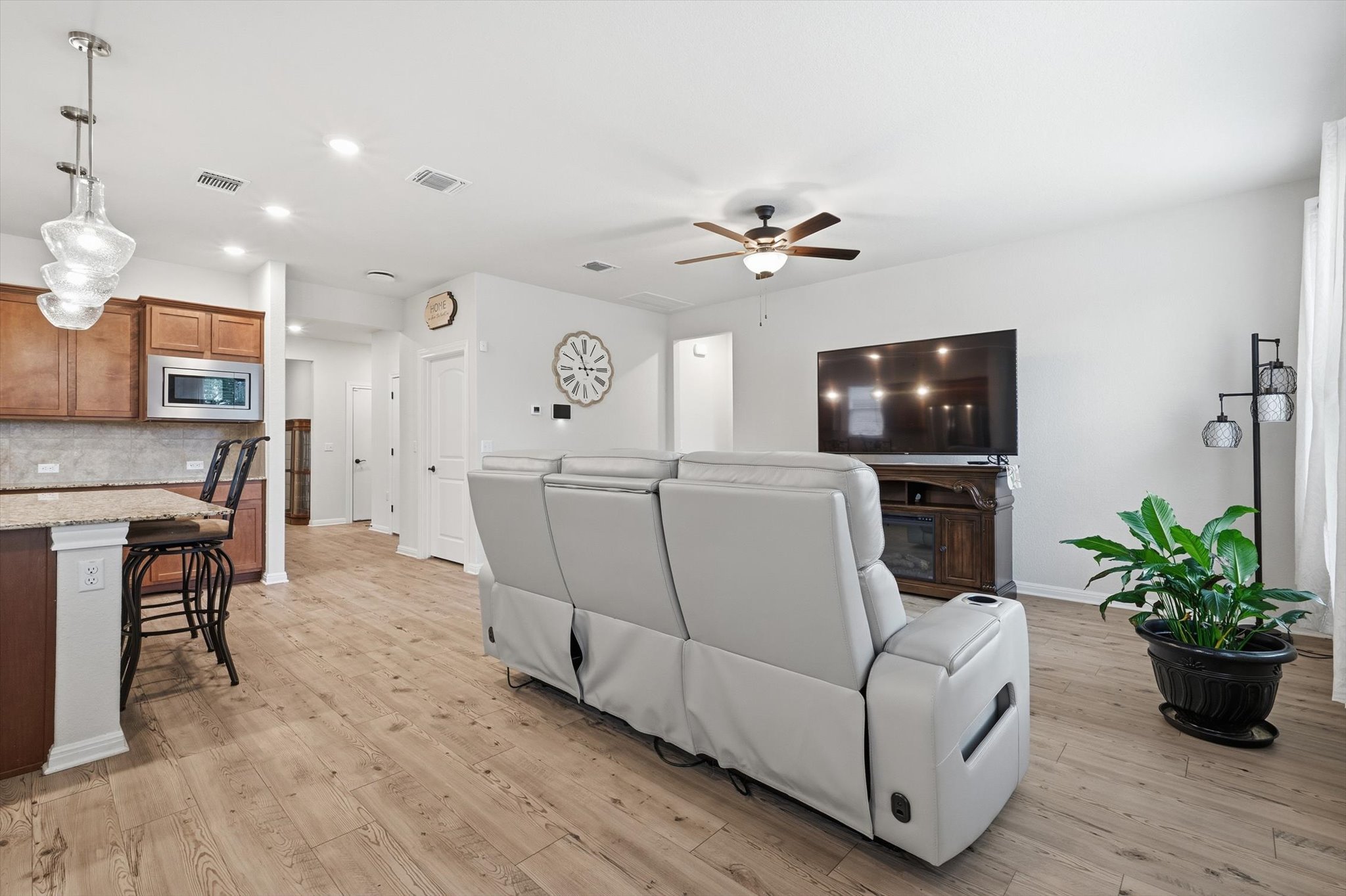 113 Lafayette Street Georgetown, TX 78633 - Photo 20 of 39 Open-concept living area with wood-finish flooring, a ceiling fan, and recessed lighting