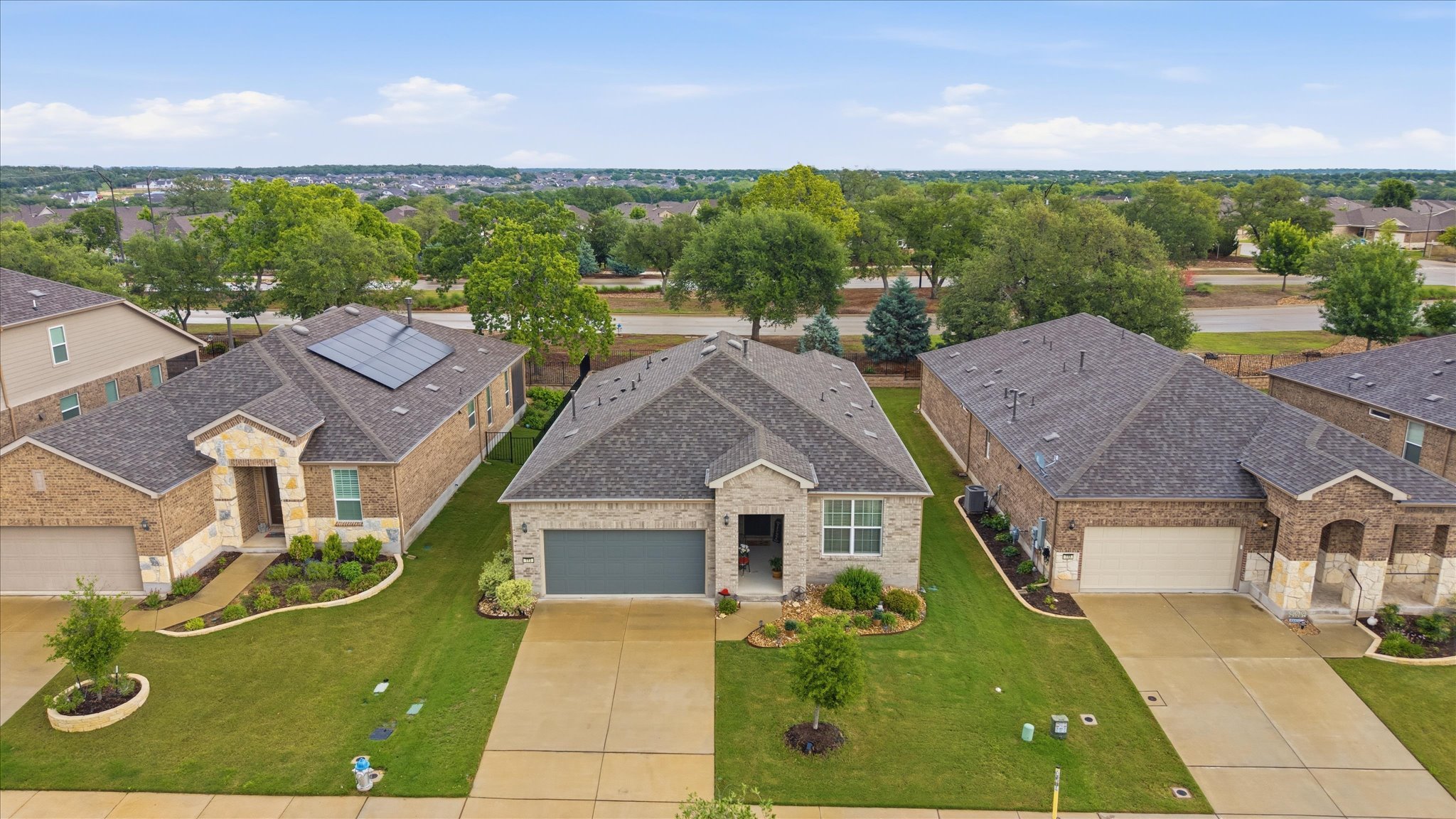 113 Lafayette Street Georgetown, TX 78633 - Photo 2 of 39 Single-story residence featuring a brick and stone facade, an attached two-car garage, and a dark shingle roof