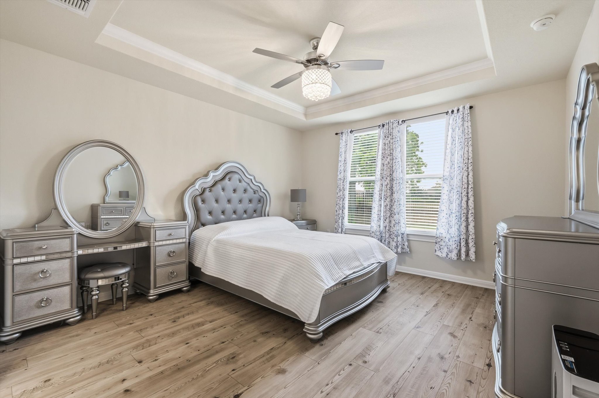113 Lafayette Street Georgetown, TX 78633 - Photo 23 of 39 Spacious room featuring tray ceilings, wood-finish flooring, and two large windows with blinds