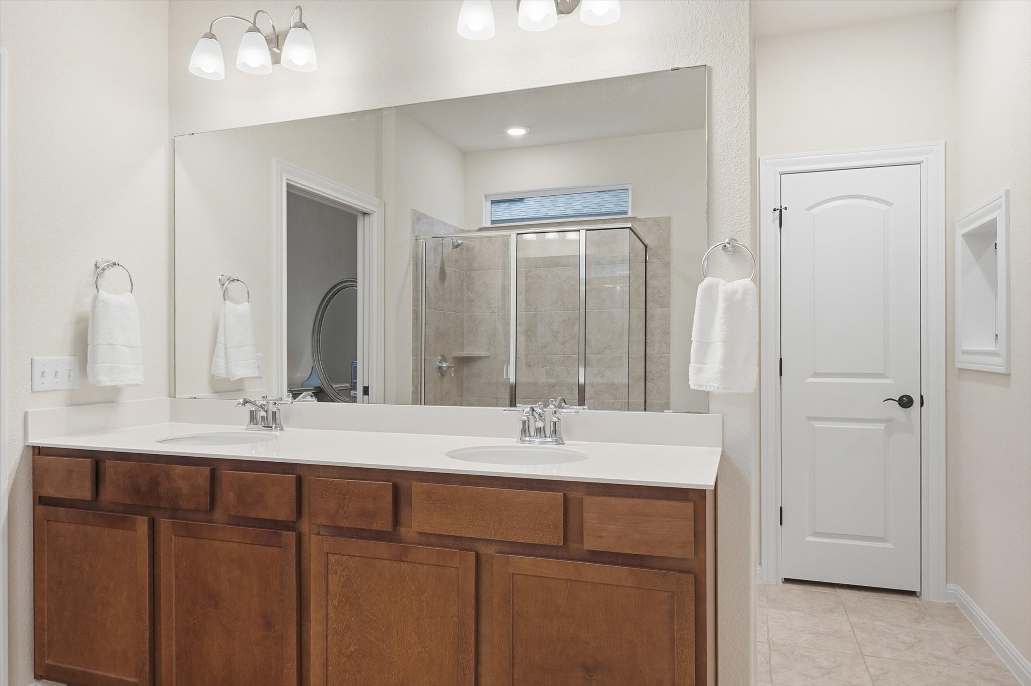 113 Lafayette Street Georgetown, TX 78633 - Photo 30 of 39 Dual sink vanity with wood-finish cabinetry and light-toned countertops