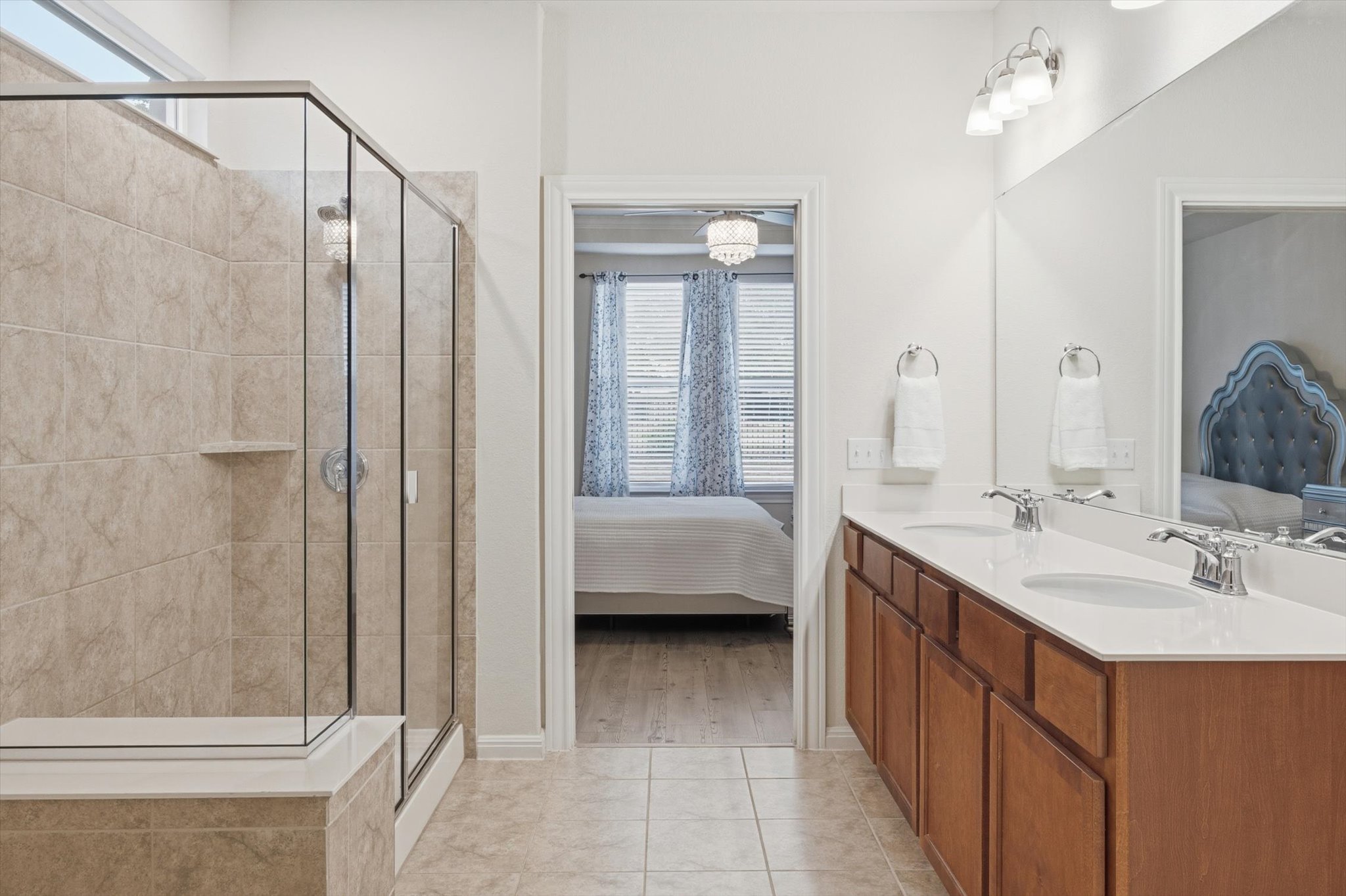 113 Lafayette Street Georgetown, TX 78633 - Photo 31 of 39 Bathroom featuring a double vanity with white countertops, wood-finish cabinetry, and chrome fixtures