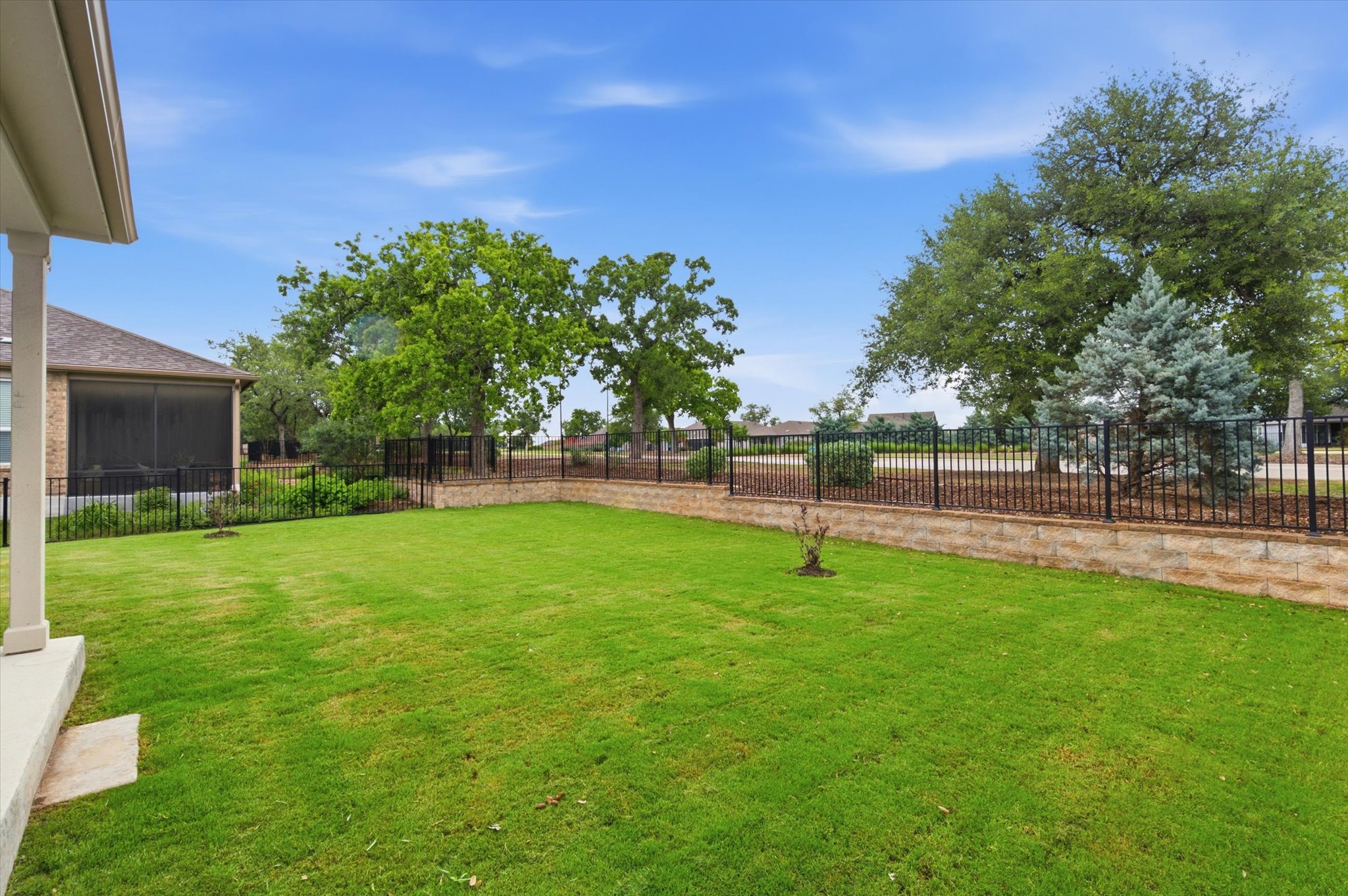113 Lafayette Street Georgetown, TX 78633 - Photo 37 of 39 Expansive backyard featuring a green lawn, mature trees, and a screened porch