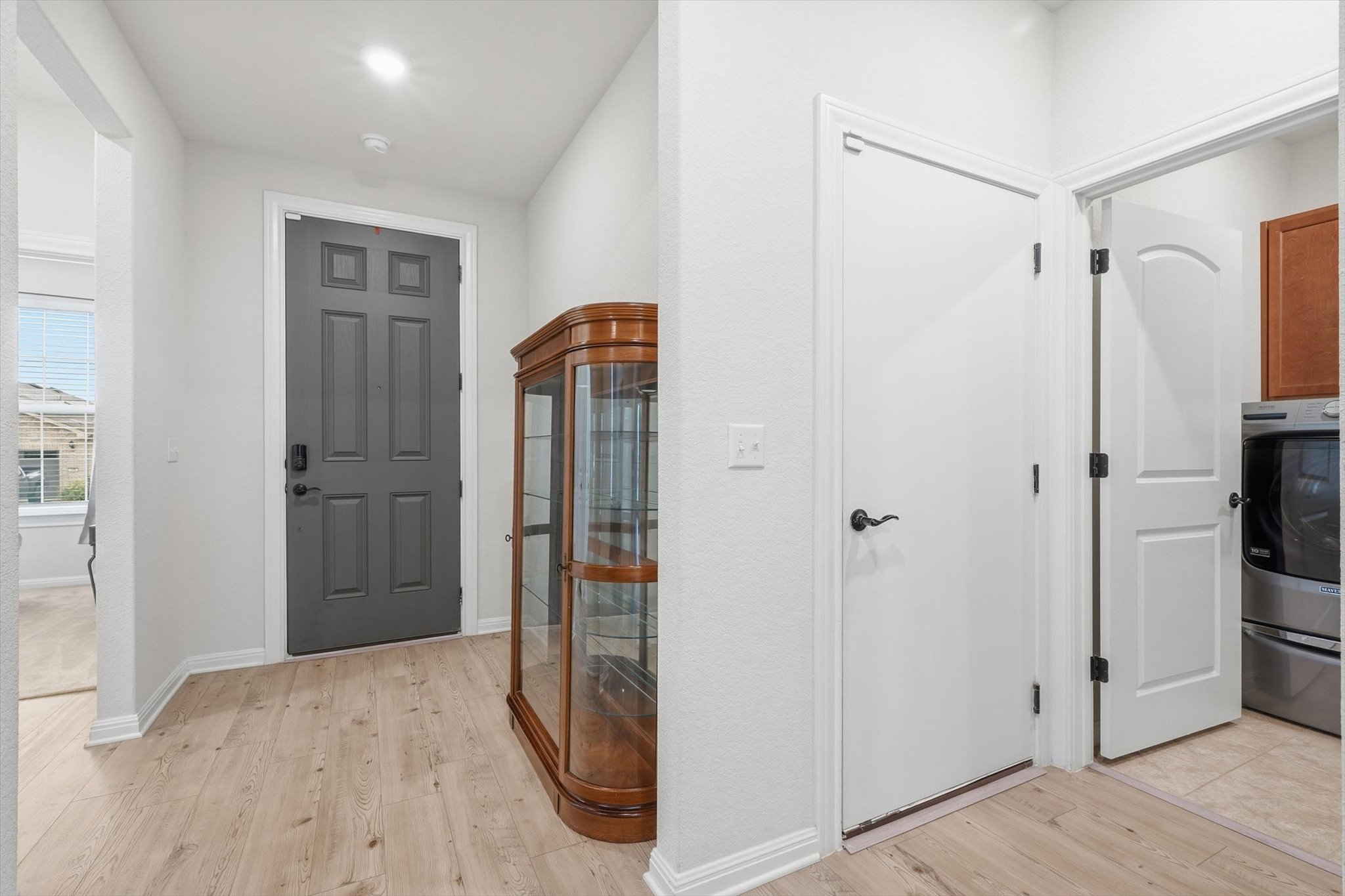 113 Lafayette Street Georgetown, TX 78633 - Photo 7 of 39 Entryway looking at Front Door (grey). To the Right is the garage door and Laundry Room. To the Left is the Secondary Bedroom and Bathroom with a two storage closets in the hallway.