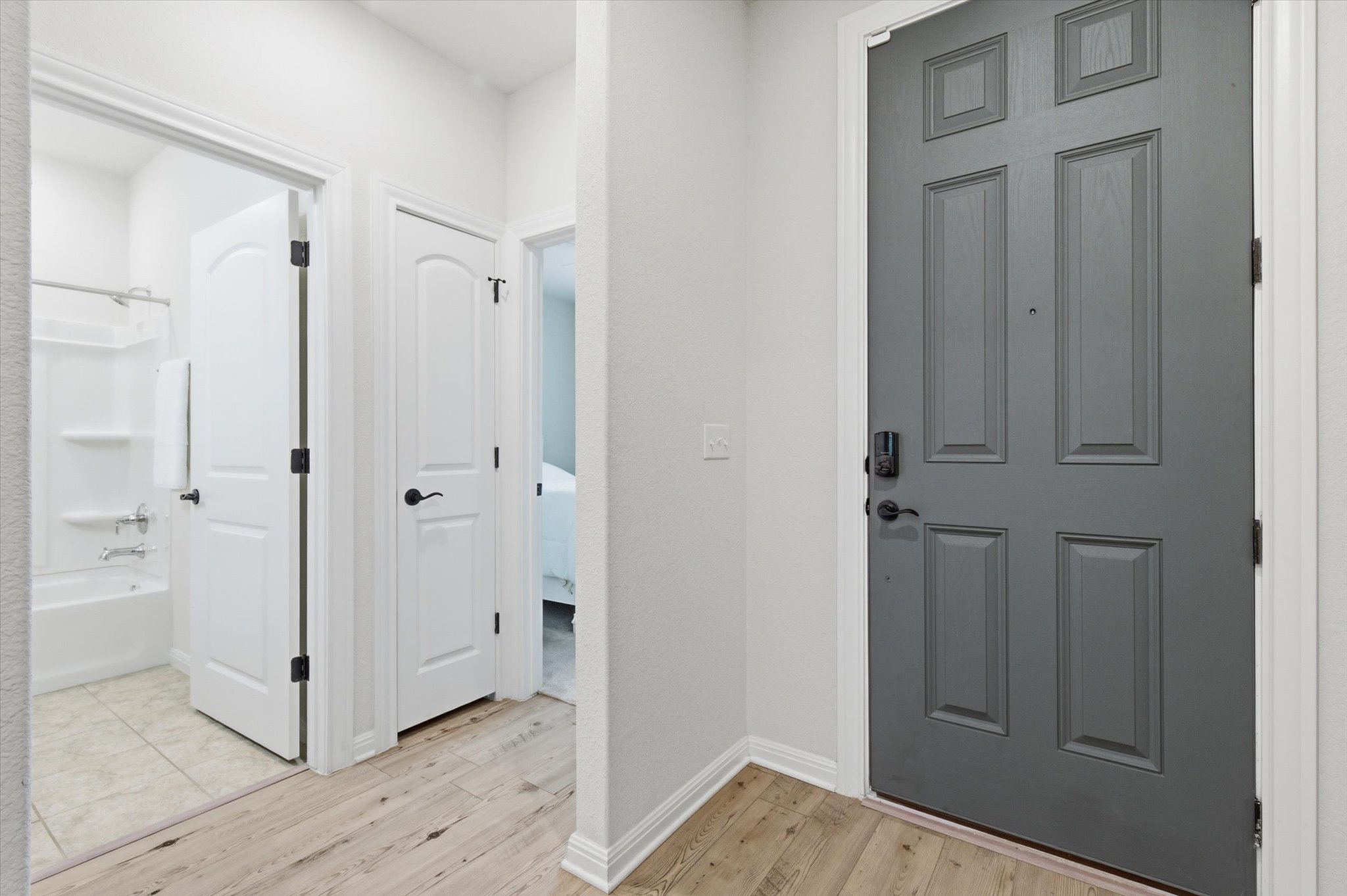 113 Lafayette Street Georgetown, TX 78633 - Photo 8 of 39 Entryway looking at front door (grey) and the secondary bathroom and bedroom are to the left with 2 closets in hallway for storage.
