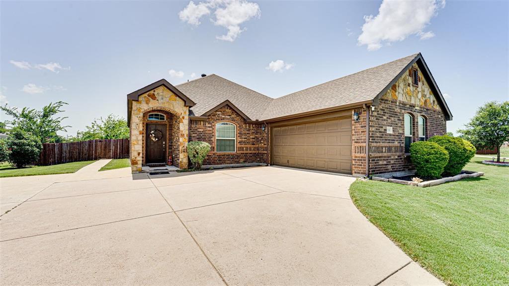 104 Anthony Lane Red Oak, TX 75154 - Photo 2 of 16 French country home featuring roof with shingles, brick siding, stone siding, driveway, and an attached garage