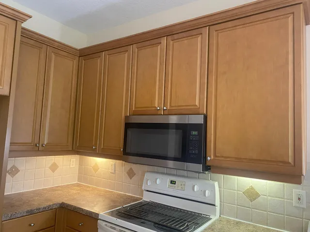 a view of a hallway with closet and a bathroom