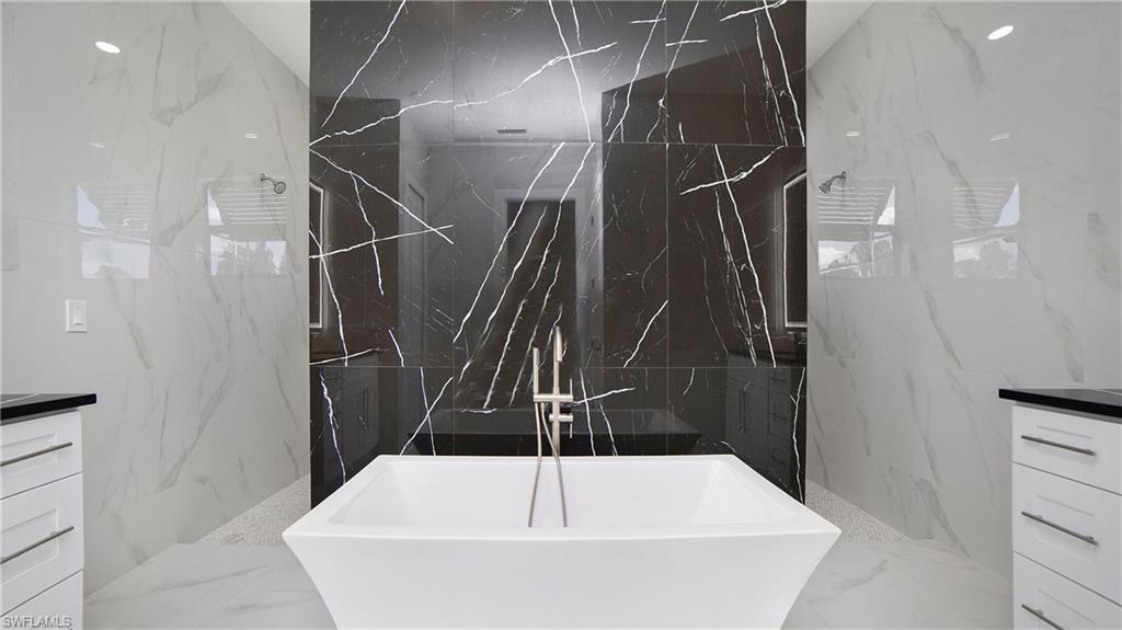 2343 Oil Well Road Naples, FL 34120 - Photo 18 of 46 Freestanding soaking tub with a floor-mounted brushed nickel tub filler