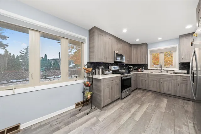 a kitchen with sink a counter top space and appliances