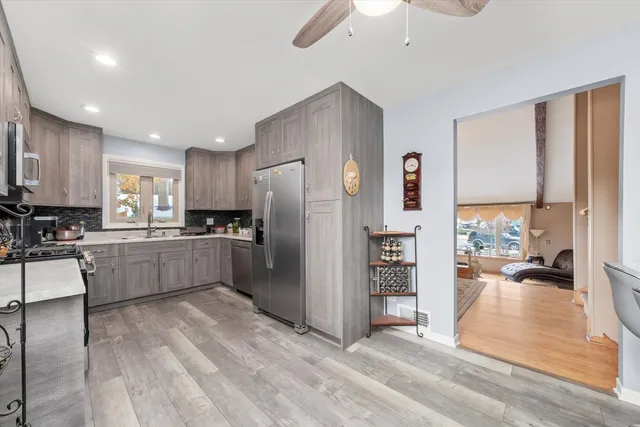 a kitchen with stainless steel appliances a refrigerator and a stove top oven