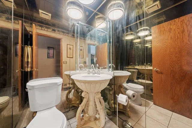 a bathroom with a toilet sink and mirror