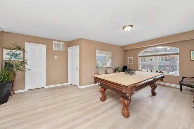 a room with pool table and windows