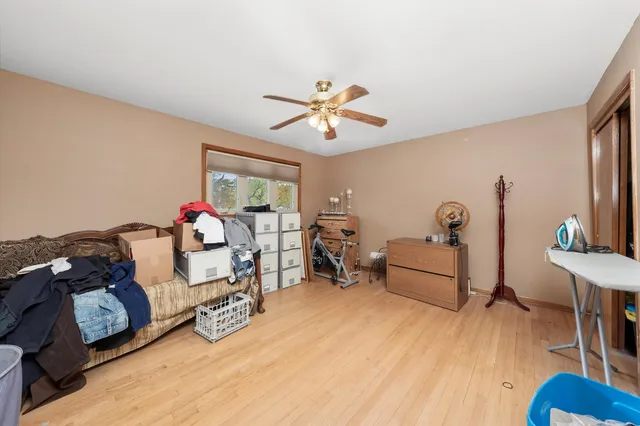 a bedroom with furniture and a wooden floor