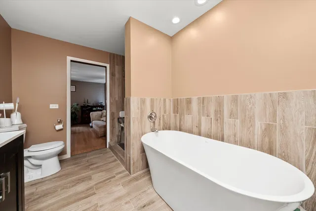 a bathroom with a bathtub and toilet