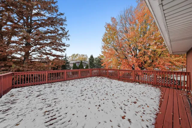 a view of balcony with wooden floor and fence
