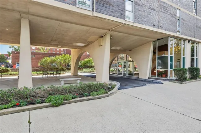a view of a brick house with potted plants
