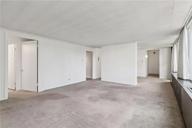 a view of an empty room and closet area