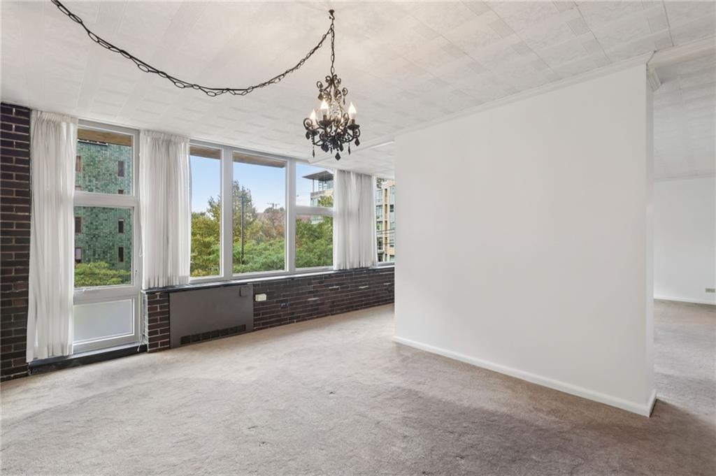 552 North Neville Street, Unit 21 Pittsburgh, PA 15213 - Photo 23 of 35 a view of a livingroom with a chandelier fan and windows