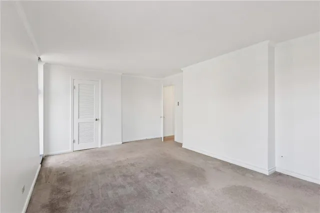 a view of an empty room and closet area