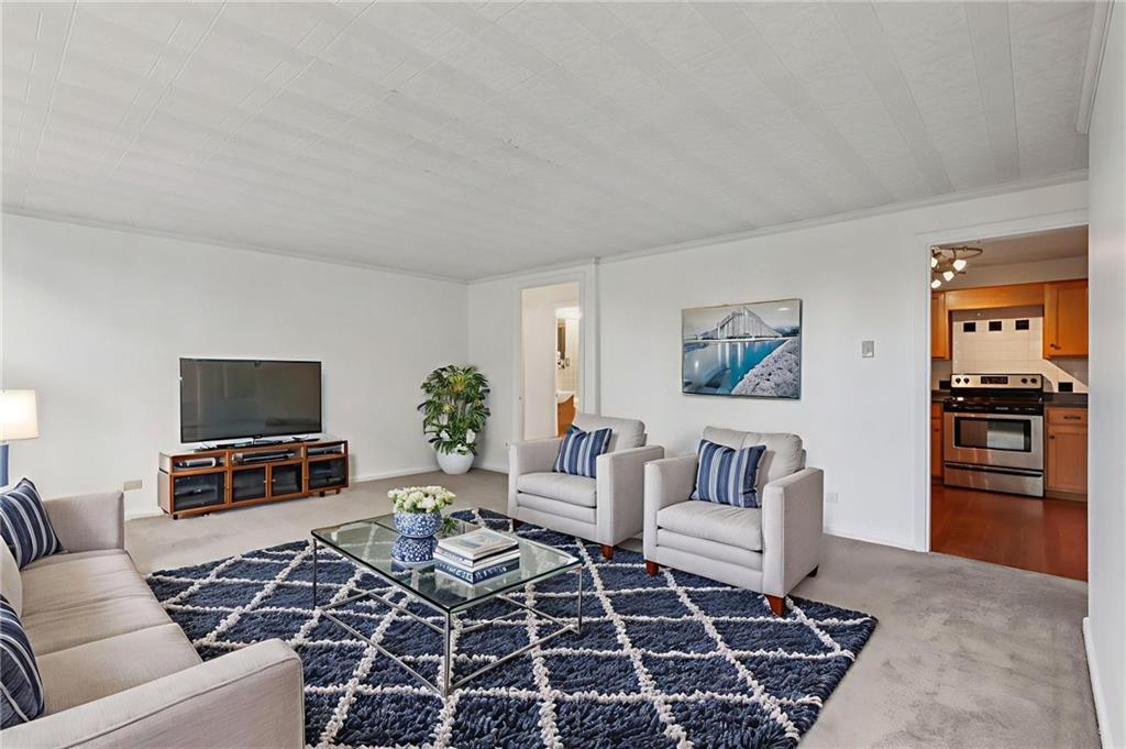 552 North Neville Street, Unit 21 Pittsburgh, PA 15213 - Photo 3 of 35 a living room with furniture and a flat screen tv