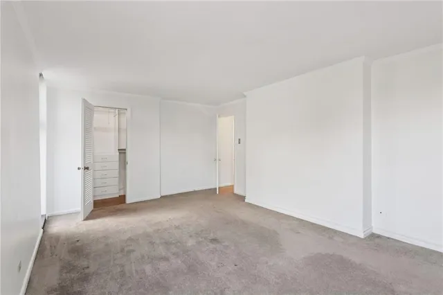 a view of walk in closet with empty racks