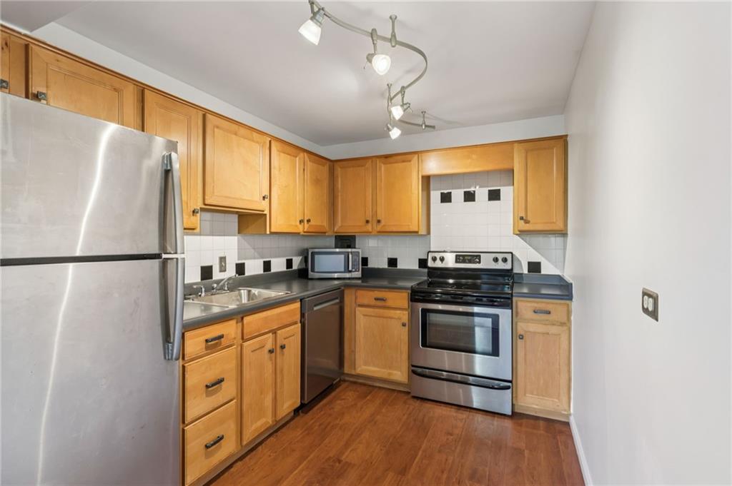 552 North Neville Street, Unit 21 Pittsburgh, PA 15213 - Photo 6 of 35 a kitchen with stainless steel appliances granite countertop a stove a sink and a refrigerator
