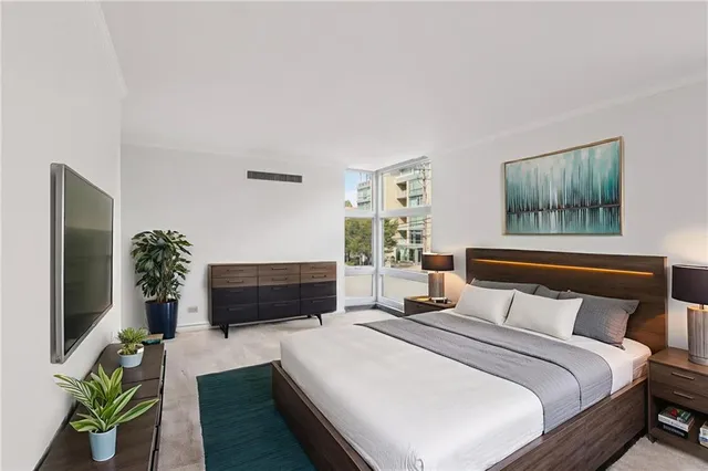 a bedroom with a bed and a flat screen tv