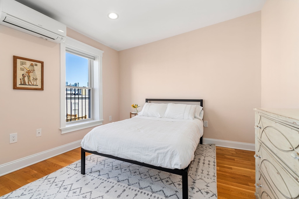 17 Walker Street Boston, MA 02129 - Photo 16 of 24 a bedroom with a bed and wooden floor