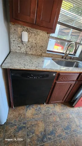 a view of a storage and utility room with refrigerator