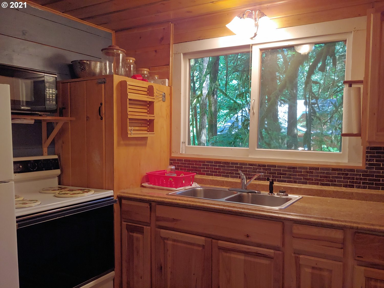 27525 Road 20 Rhododendron, OR 97049 - Photo 13 of 22 a kitchen with a sink and large window