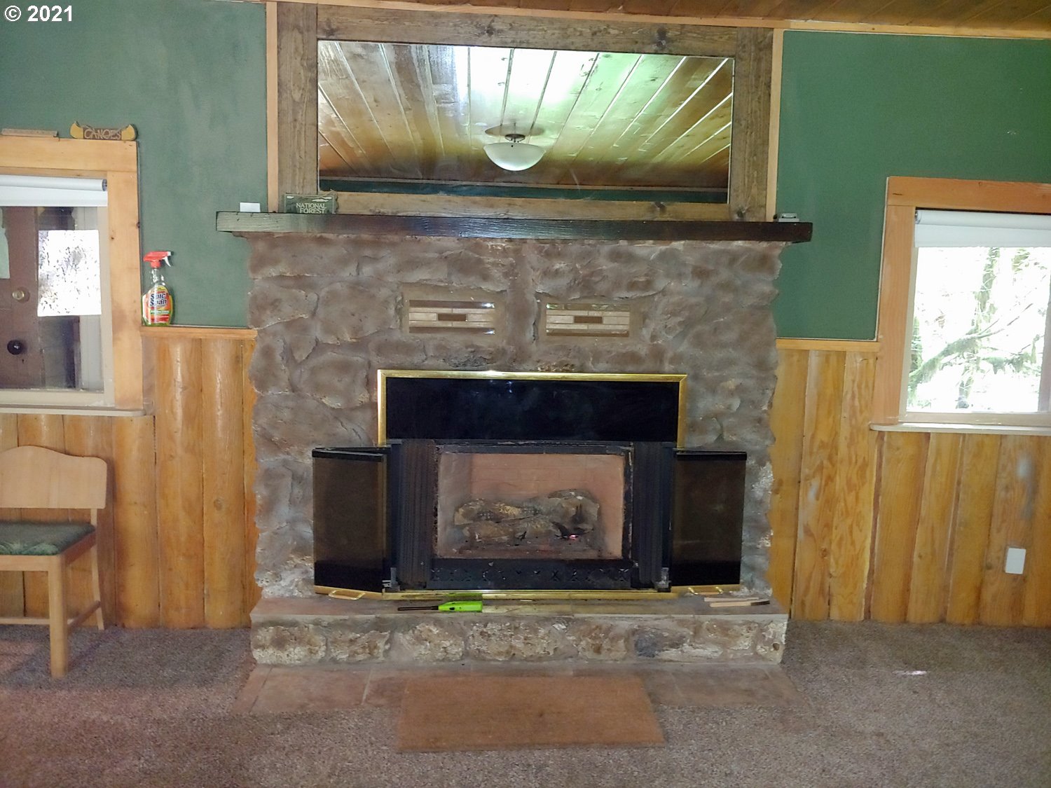 27525 Road 20 Rhododendron, OR 97049 - Photo 6 of 22 a fireplace with a clock on top of it