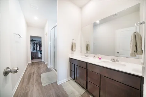 a bathroom with a double vanity sink and mirror