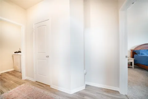 a view of a bedroom with wooden floor