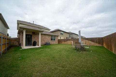 a view of a house with backyard and porch