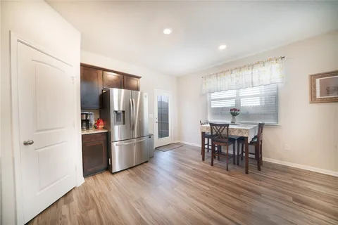 a kitchen with stainless steel appliances granite countertop a refrigerator and a stove top oven