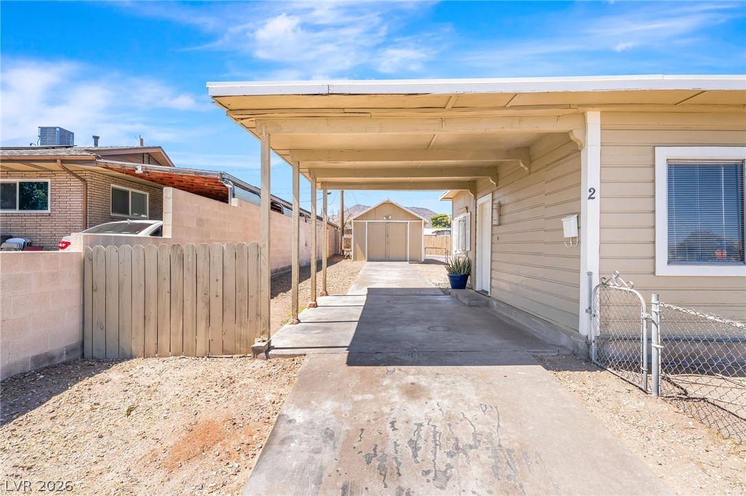 2 California Way Henderson, NV 89015 - Photo 5 of 29 A deep carport provides shaded parking and leads to a garage in the rear.
