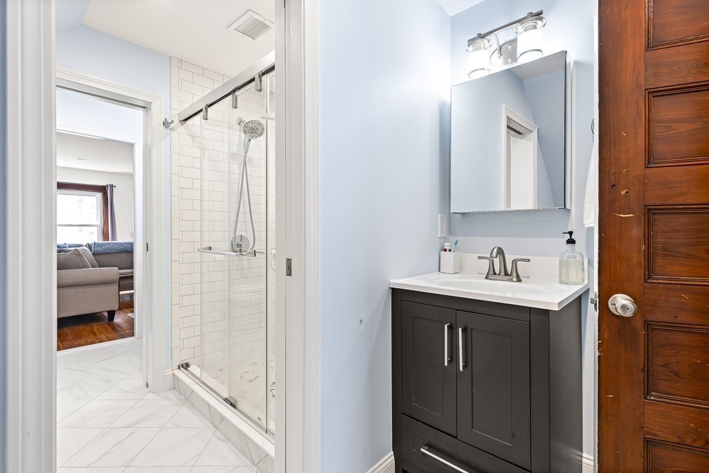 55 Main Street Somerville, MA 02145 - Photo 21 of 28 a bathroom with a sink vanity toilet and shower