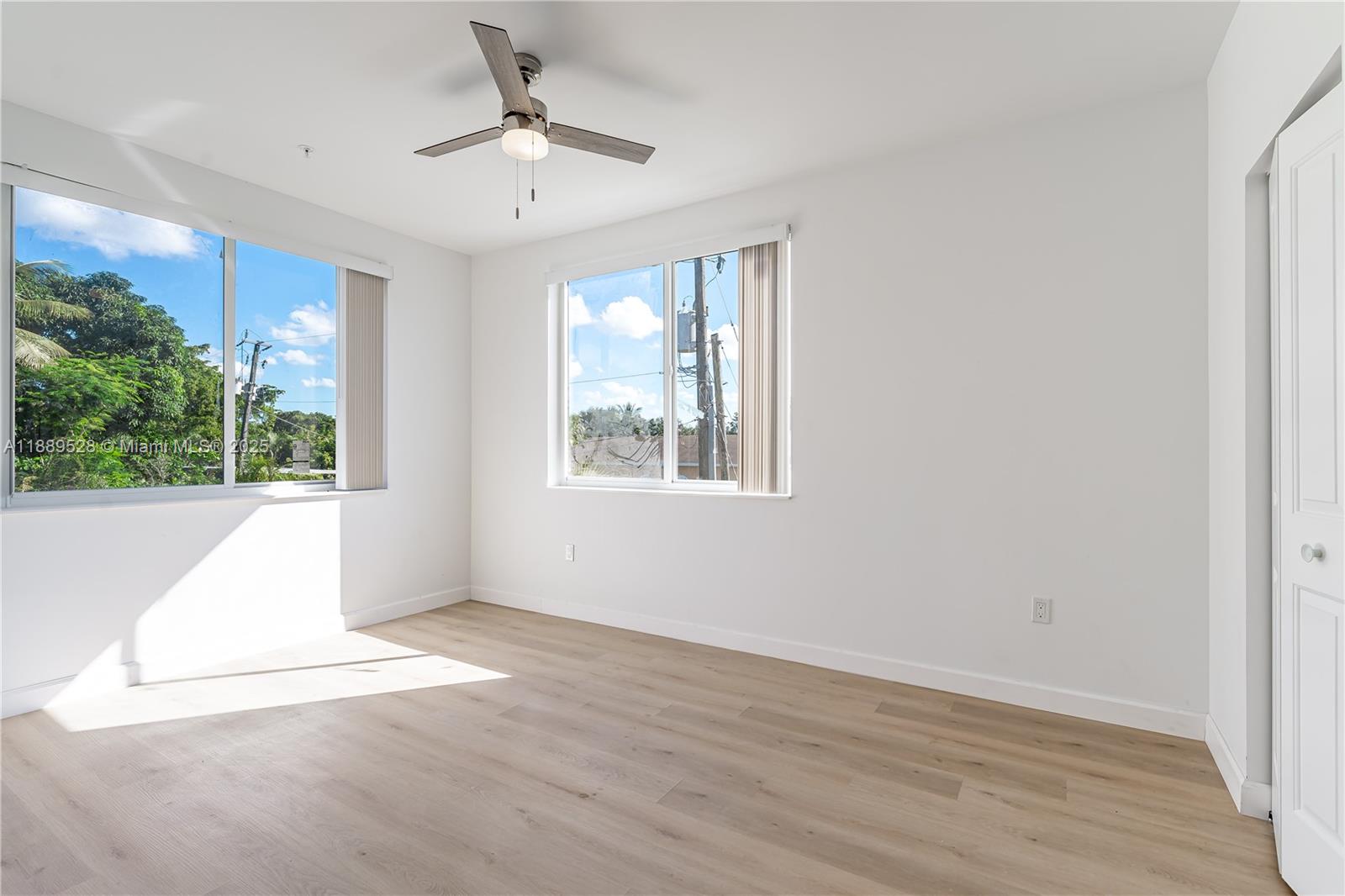 2575 Southwest 64th Avenue, Unit 7 Miramar, FL 33023 - Photo 11 of 13 a view of an empty room with a window and wooden floor