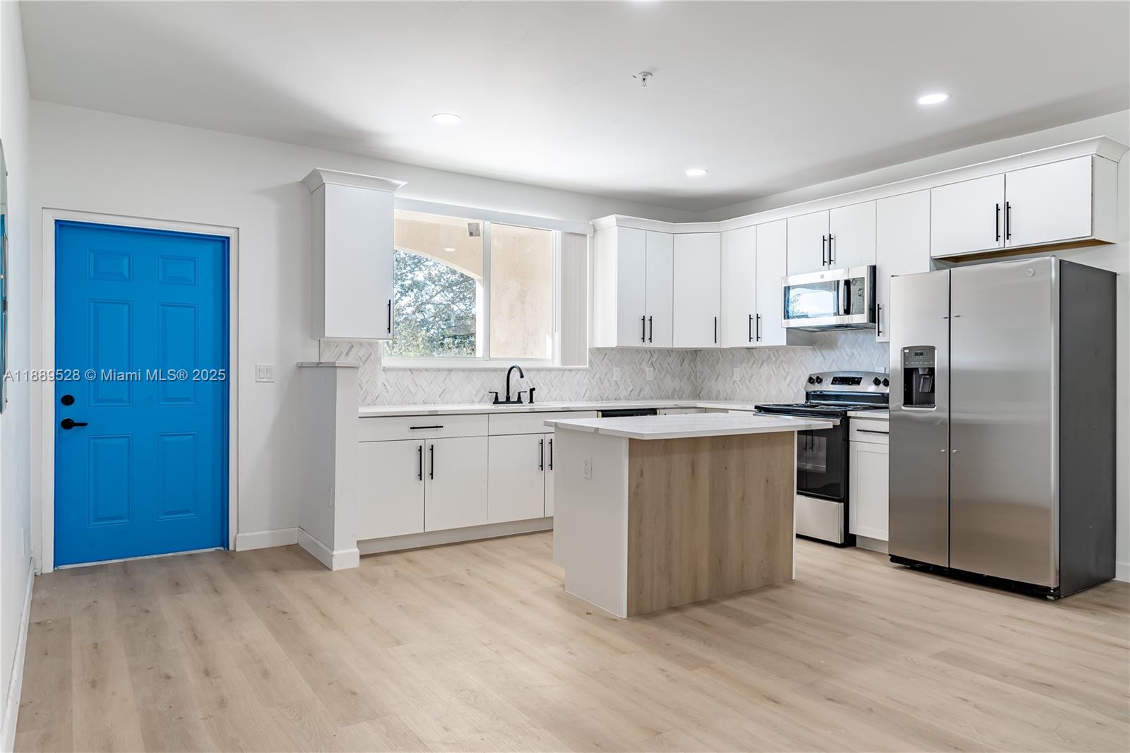 2575 Southwest 64th Avenue, Unit 7 Miramar, FL 33023 - Photo 3 of 13 a kitchen with a refrigerator stove top oven and sink