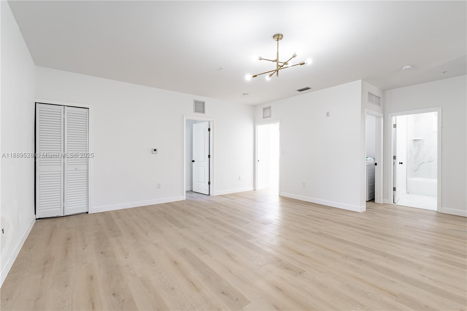 2575 Southwest 64th Avenue, Unit 7 Miramar, FL 33023 - Photo 6 of 13 a view of an empty room with wooden floor